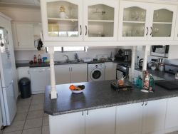 Open plan fully equipped kitchen with stove, fridge, washing and dishwasher 
