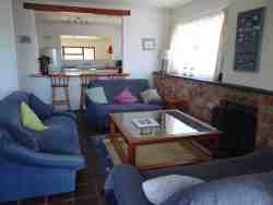 The lounge area with fireplace looking towards the kitchen