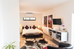 Patio Self-Catering Suite.  Large leather king-size bed