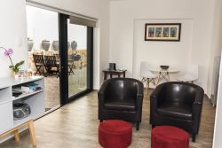 Self-Catering Patio Suite lounge, dining area, glass sliding doors