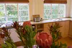 Kitchen area with open plan dining and lounge in Suite 5