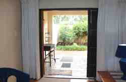 French front door with security leading to patio