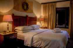 Lodge bedroom with ensuite bathroom with bath