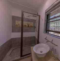 Remington Villa - Bedroom 2. Ensuite - Shower, toilet, and basin.