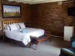 Queen bed, balcony. Bar fridge and TV