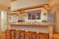 Upstairs kitchen with hob, oven, fridge freezer, microwave and dishwasher