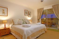 Bedroom 1: (Upstairs) Main bedroom (en suite bathroom and lounge area opening onto upper deck