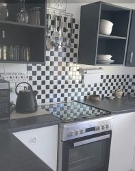 Fully equipped kitchen, stove top, microwave, cooking/eating utensils, access to small braai area for kettle braai, seating.