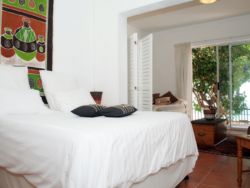 There is a Queen size and a double bed in this large double room with a partial screen. This is the 2nd bedroom and is downstairs, leading out onto the pool area and overlooking the ocean