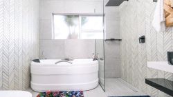 Bedroom 5 ensuite bathroom with bath and shower