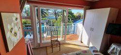 Burgundy Room balcony with view of pool and garden