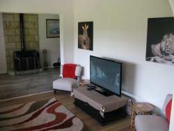 The house lounge has an anthracite heater and has a large flat screen TV with 90 DSTV channels. 