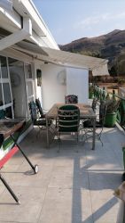 The Clarinet patio has a built in braai and furniture with a retractable awning to enjoy the sunrise and sunset 
