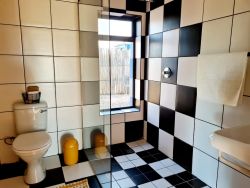 The house has two bathrooms as well as a separate toilet amounting to: three toilets, three basins, one bathtub, two showers (one indoor, one outdoor).