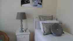 A single bed together with a double bed in this spacious bedroom is ideal for family members or for children.