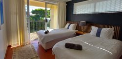 Bottom bedroom with two single beds that can be pushed together to make a king. 