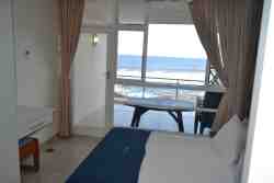Sea Front 16, main bedroom and door to private balcony.