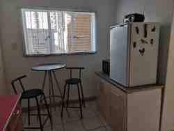 Unit 2 Eating table with Fridge/Freezer and microwave