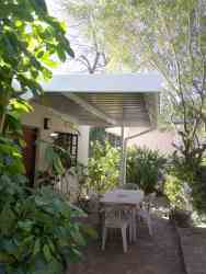 Outside 4 sleeper garden flat sit under awning 