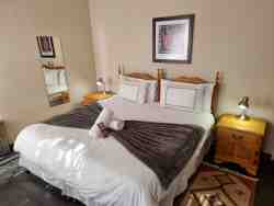 A view of a Standard Luxury room. This one has a king- or twin bed configuration, Air-conditioned and self catering and HD TV with DSTV. 