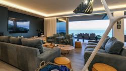 Main lounge with indoor fireplace and sea views