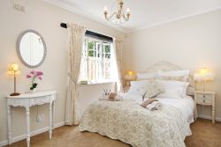 French room with Queen extra length bed. This elegant bedroom leads onto the family bathroom