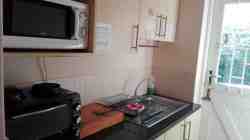 Cottage Kitchenette - passage leads outside to private braai patio