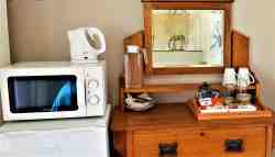 Stone Room - fridge, microwave & kettle with complementary breakfast snack tray.