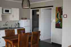 Pecan Tree Cottage dining area with view to second bedroom ( twin single beds)