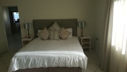 Upstairs Master bedroom with King size bed and en-suite bathroom with a shower and bath.