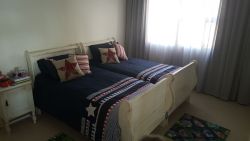 Second bedroom upstairs with two single beds.