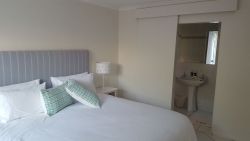 Downstairs bedroom with king size bed and en-suite bathroom with shower.  