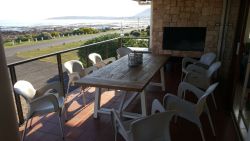 Spacious front patio with eight-seater table and build-in BBQ.  Beautiful views and sunsets.
