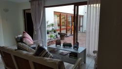 Small lounge downstairs overlooking backyard with pool.