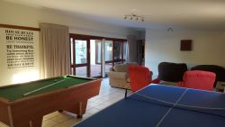 Games room with dart board, pool table and table tennis.