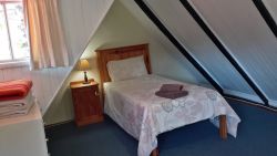 Haven loft bedroom with 2 single beds and a balcony
