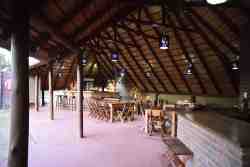 A Lapa is a shelter where everyone can sit comfortably together.  Our lodge has self-catering chalets, but it is also possible to enjoy breakfast and/or dinner in the Lapa for a fee. In addition, the Lapa has a cozy bar where you can enjoy a cool drink. 

In addition to enjoying a snack and/or drink, you can certainly enjoy the view over the bush during the day and an unforgettable sunset with the fire pit on in the evening. You just don’t want to miss that!