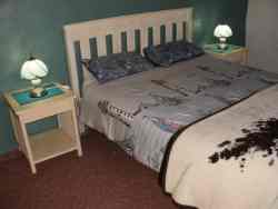 The Lighthouse Room queen bed, extra length, en suite with single bed