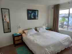 Bedroom with two single beds and large buit in cupboards.