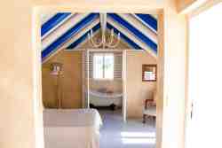 Die Opstal Top loft apartment, sleeping one couple, or two persons, open plan bedroom and bathroom with romantic Victorian bath only