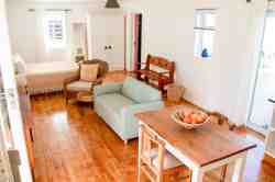 Die Opstal Studio apartment, sleeping one couple, or two persons,  with direct access to the swimming pool in the courtyard.  The main big front stoep is the entertainment braai area under the fig tree