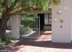 Entrance through secure gates under the old peppertree!
