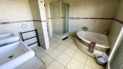 Deluxe room 1 en-suite bathroom, corner tub and shower