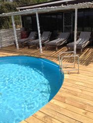 Pool deck with loungers and shade