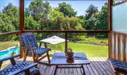 Room 1 has a private balcony overlooking the swimming pool, outdoor covered barbeque and parkland garden
