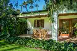 Outside patio with free-standing braai and table and chairs with views of the mountain and gardens.