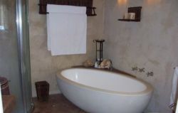 This is main bedroom's bathroom en-suite with stone bath, sep shower, bidet, toilet & stone hand basin.  