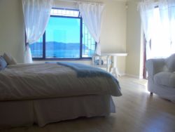 Main Bedroom (king bed) & single day bed - with sea views & French doors to patio.
