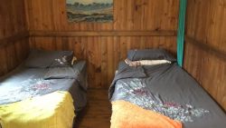 Basic private cabin Twin/Double. The two twin beds can be pushed together to make one large double. This cabin is situated near the main buildingAccess to Communal bathrooms and kitchen facilities. Access to Communal bathrooms and kitchen facilities.