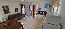 Cottage 1 - open plan kitchen & living area with double sleeper couch